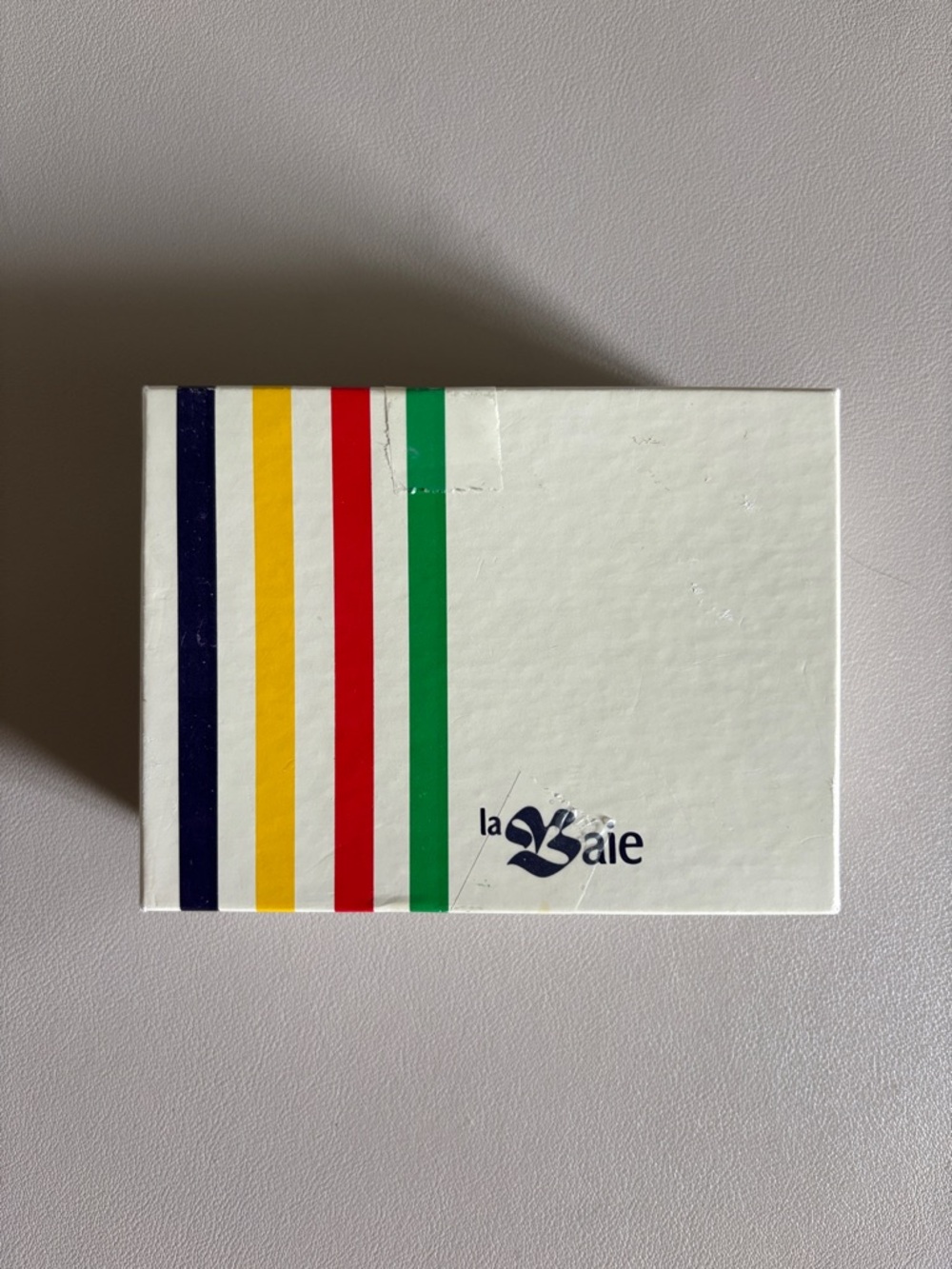 The Hudson’s Bay White Accessory Box with Multicolor Stripe Design